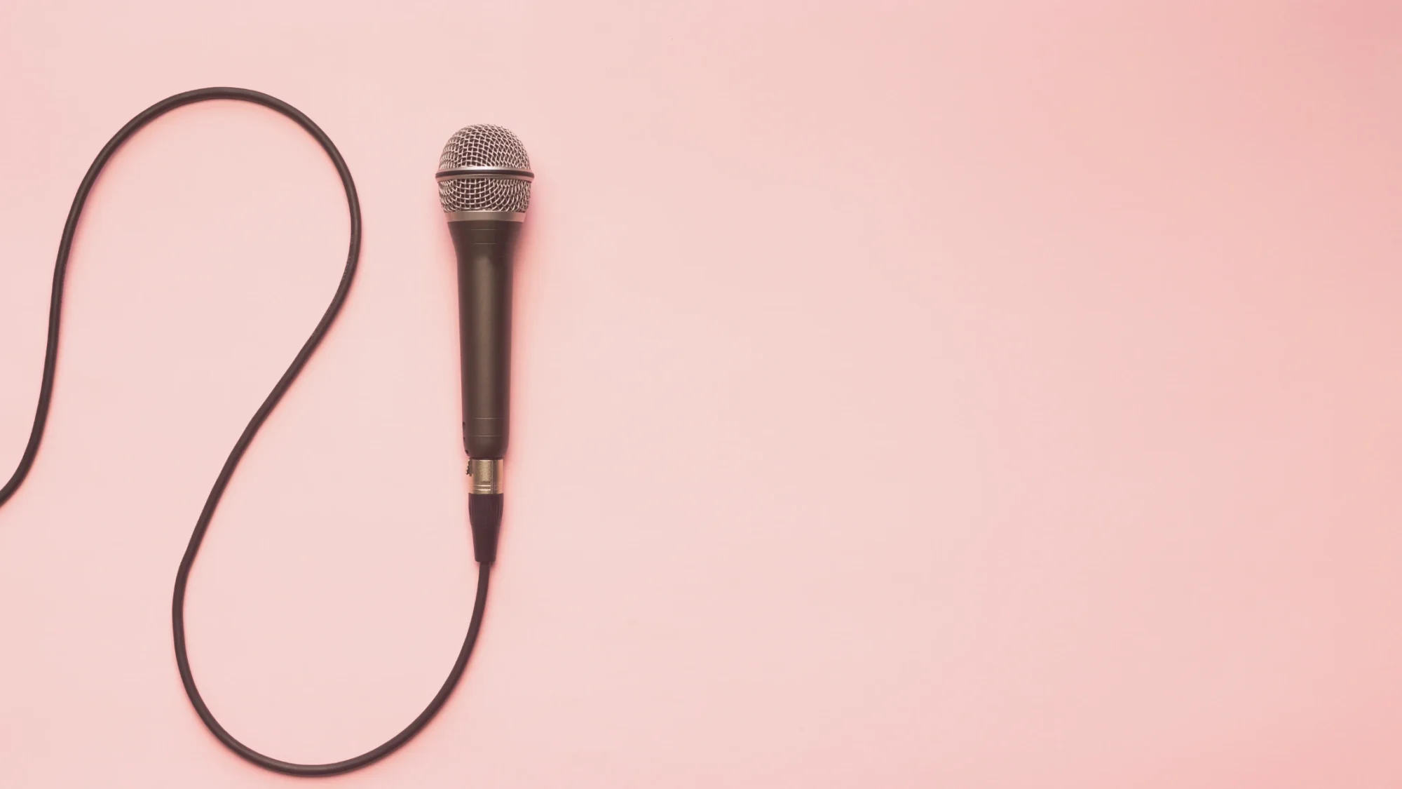 Black silver microphone on pink background (Wedding MC)