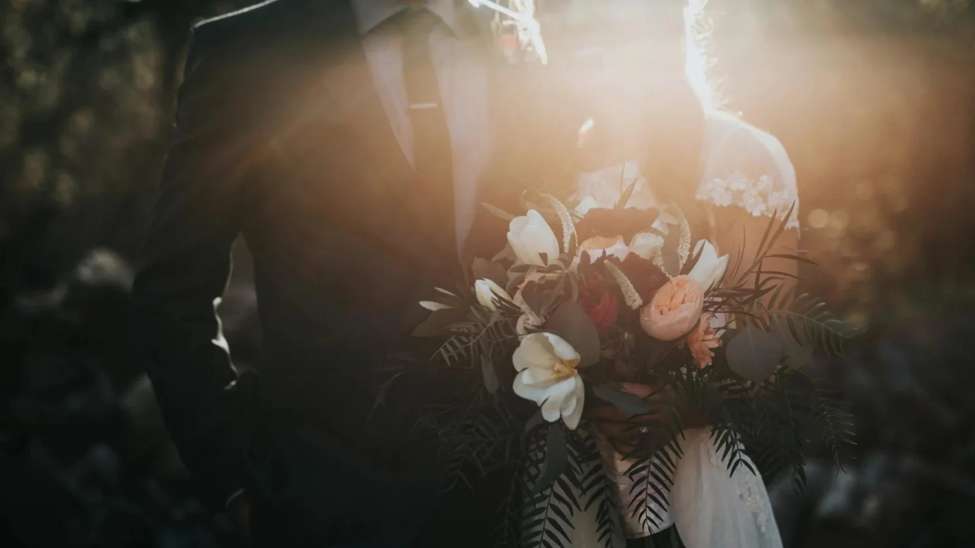 groom beside bride holding bouquet flowers