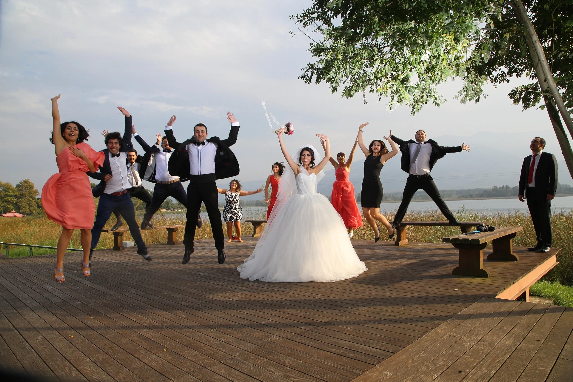 Newlyweds and Wedding Party jumping