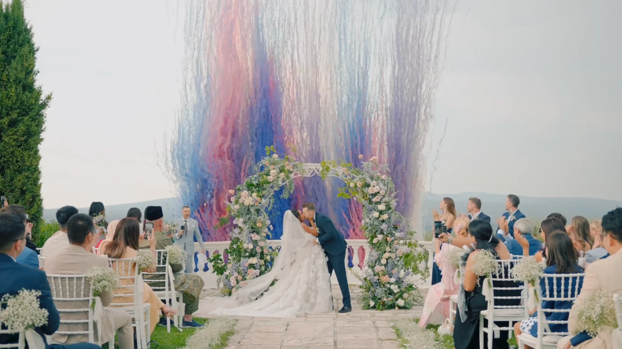 Bride and groom kissing at the end of their wedding ceremony in Rome's countryside.